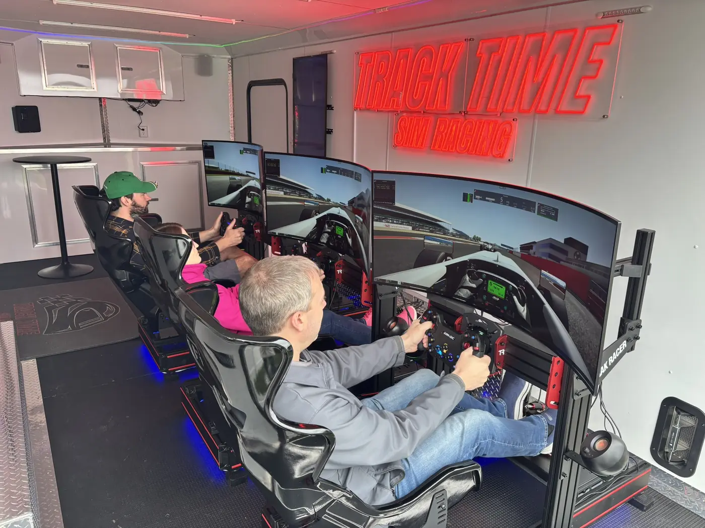 Three guests racing side by side inside the trailer