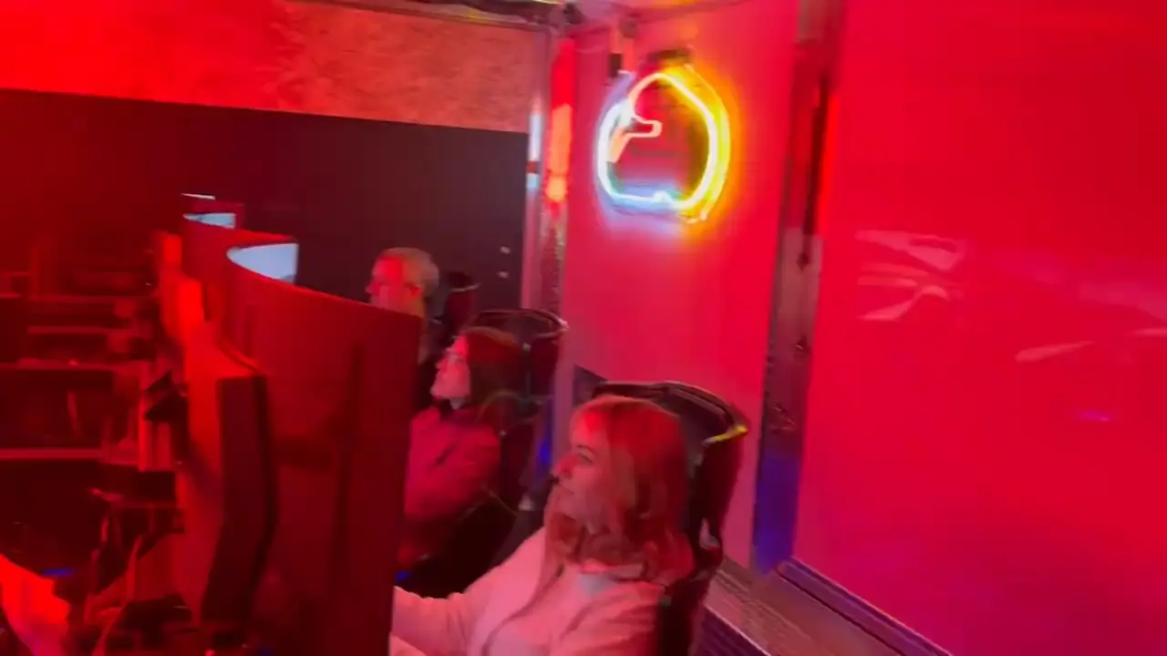 The trailer interior glowing under red neon