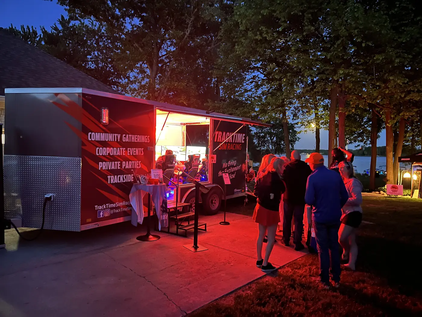 The trailer lit up in red at an evening event