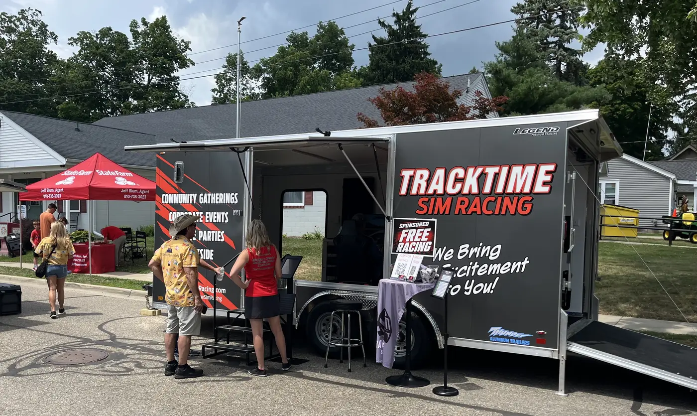 The Track Time trailer next to a sponsor tent at an outdoor event