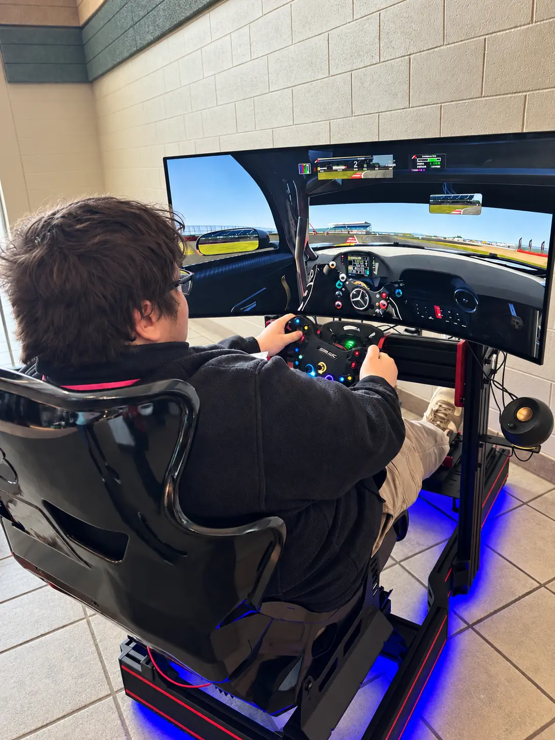 A guest racing on a simulator inside a business