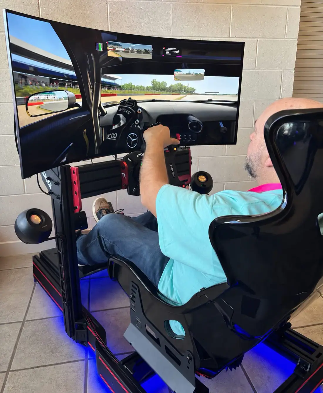 A customer racing on a Track Time simulator inside a business